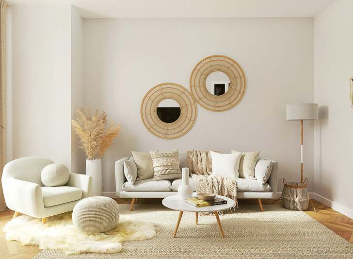 Bright, modern teen bedroom with light gray walls, a navy upholstered bed with geometric throw pillows, floating desk, and open shelving displaying books and plants